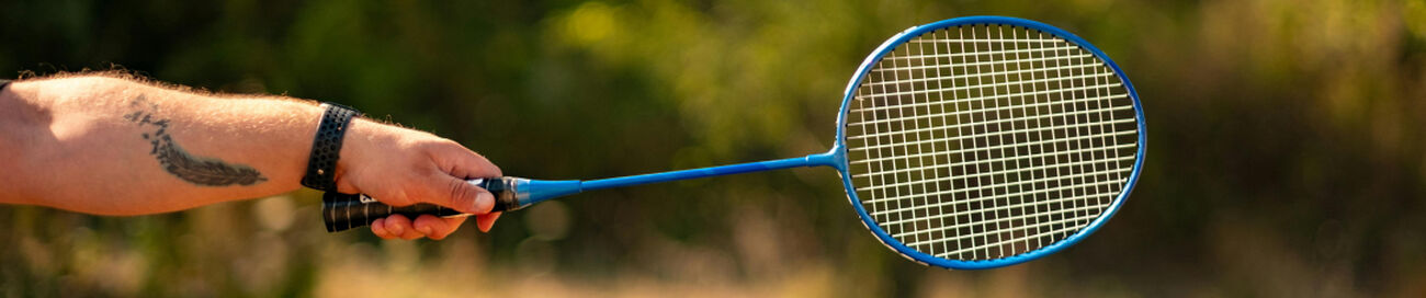 person holding badminton racket