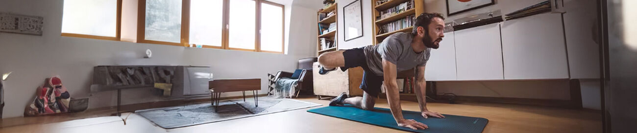 Man engaged in exercise with a floor mat on the floor