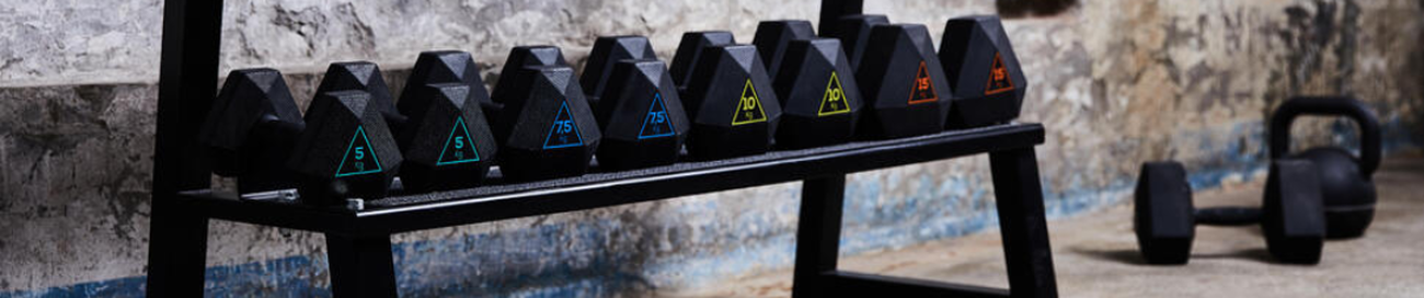 Different weight dumbbells lined on a stand