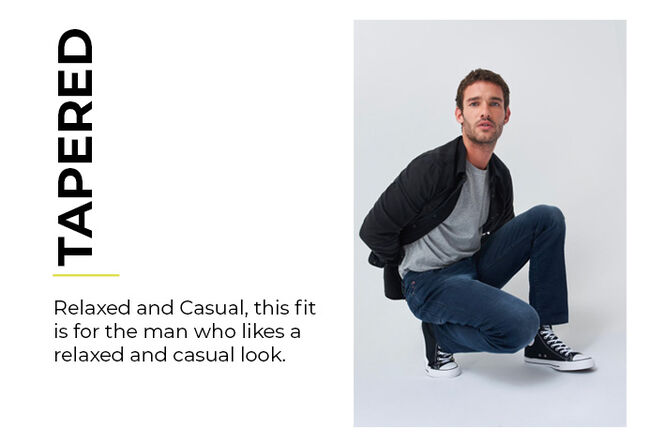 man in tapered dark blue jeans